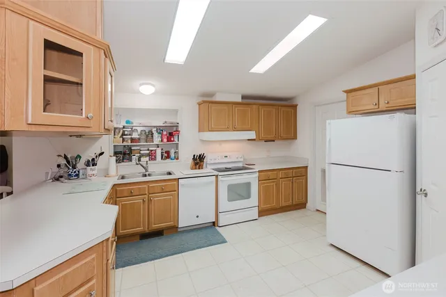 a kitchen with a sink stove and refrigerator