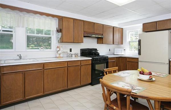 59 Stuart Road Newton, MA 02459 - Photo 4 of 5 a kitchen with stainless steel appliances granite countertop a sink a stove a dining table and chairs