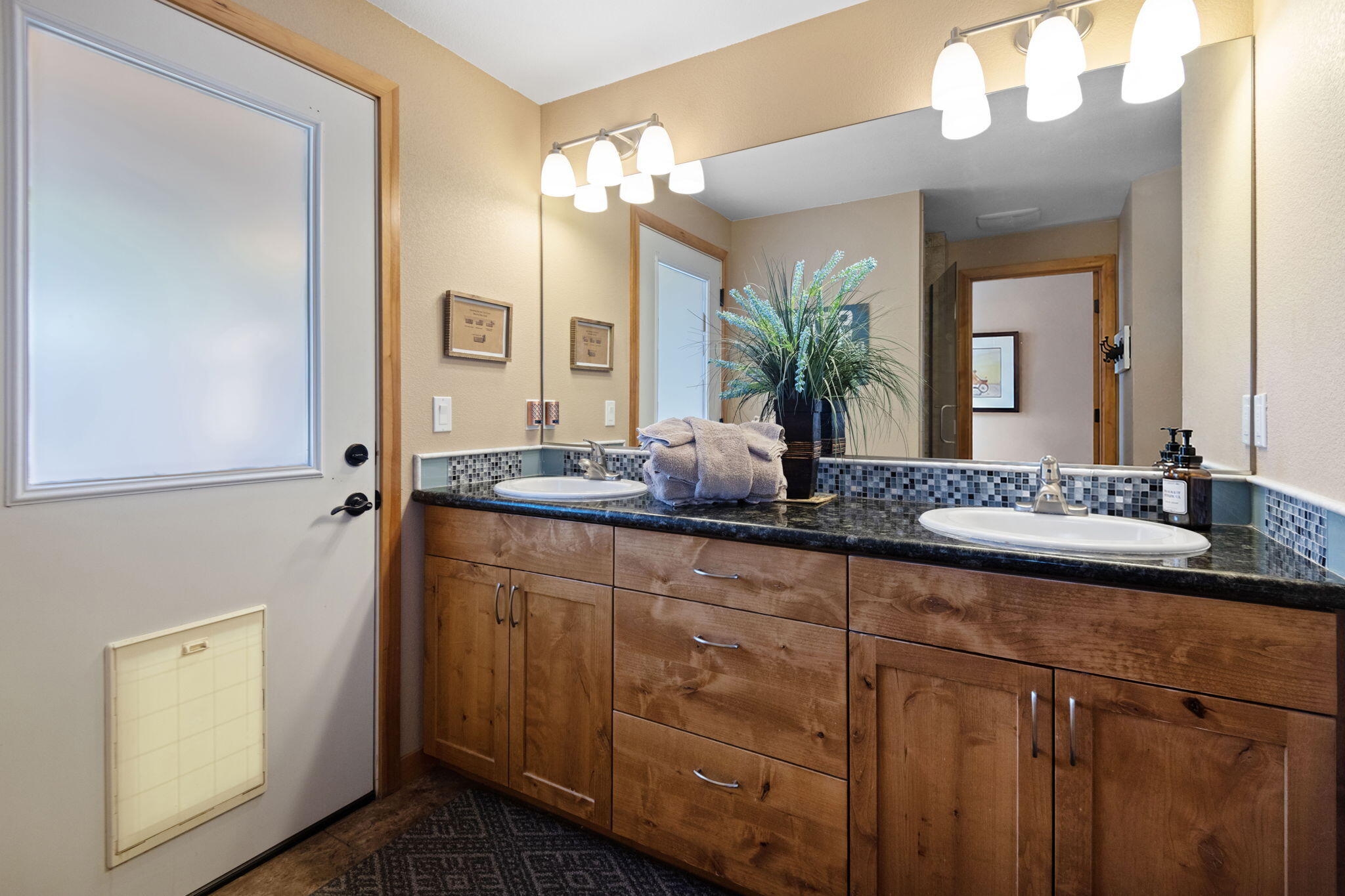 22539 Martee Lane Bend, OR 97701 - Photo 19 of 54 a bathroom with a granite countertop sink and a mirror