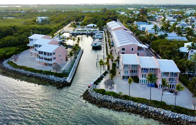 an aerial view of multiple houses with a yard