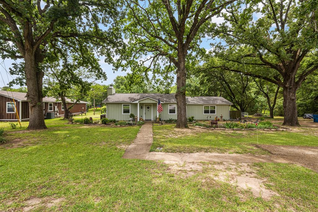 713 Midway Road Tool, TX 75143 - Photo 4 of 28 a front view of a house with a garden