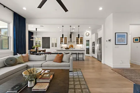 a living room with furniture and wooden floor