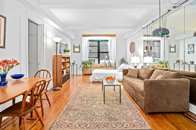 a bedroom with furniture and a large window