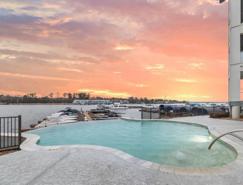 199 Waterpoint Court, Unit 302 Conroe, TX 77356 - Photo 18 of 20 Escape to serenity! This exclusive infinity-edge pool offers breathtaking views of the lake, perfect for a peaceful swim or lounging in pure luxury. This pool is reserved for adults only.