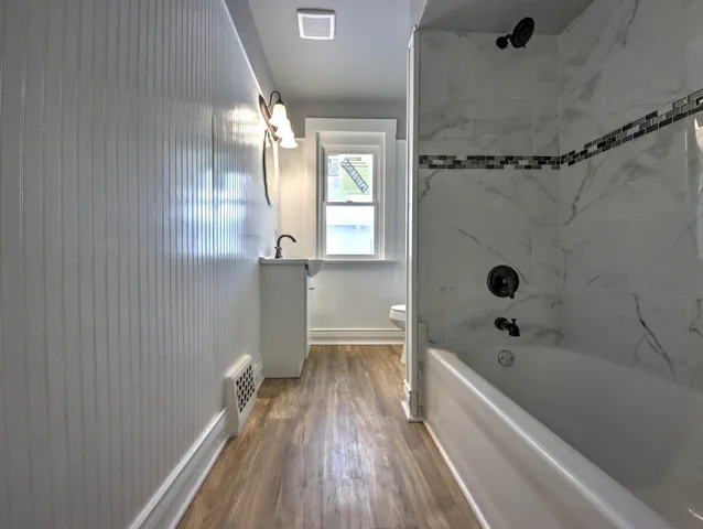 a bathroom with a bathtub and shower
