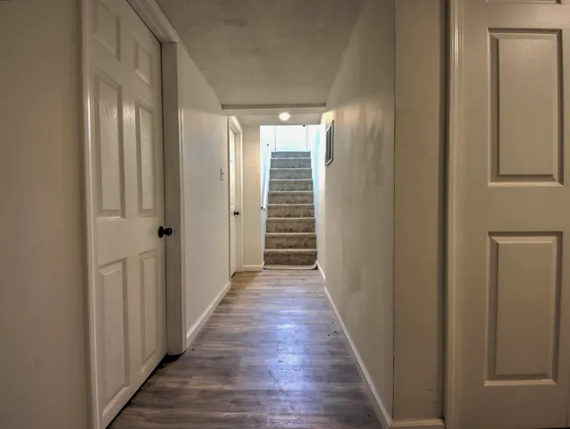 a view of a hallway with wooden floor