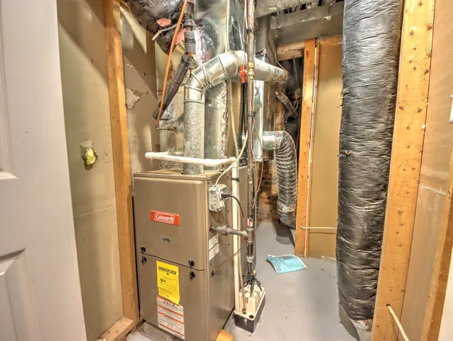 a front view of house with yard and trees in the background