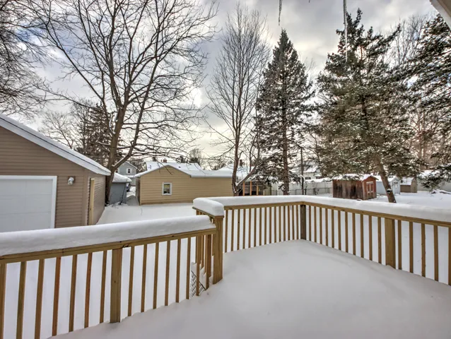 a view of house with yard and trees in the background