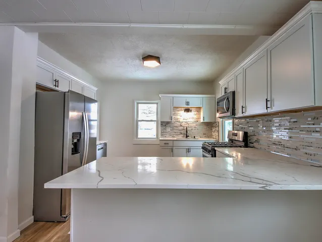 a kitchen with counter top space cabinets and stainless steel appliances