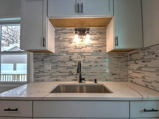 a kitchen with a sink and cabinets