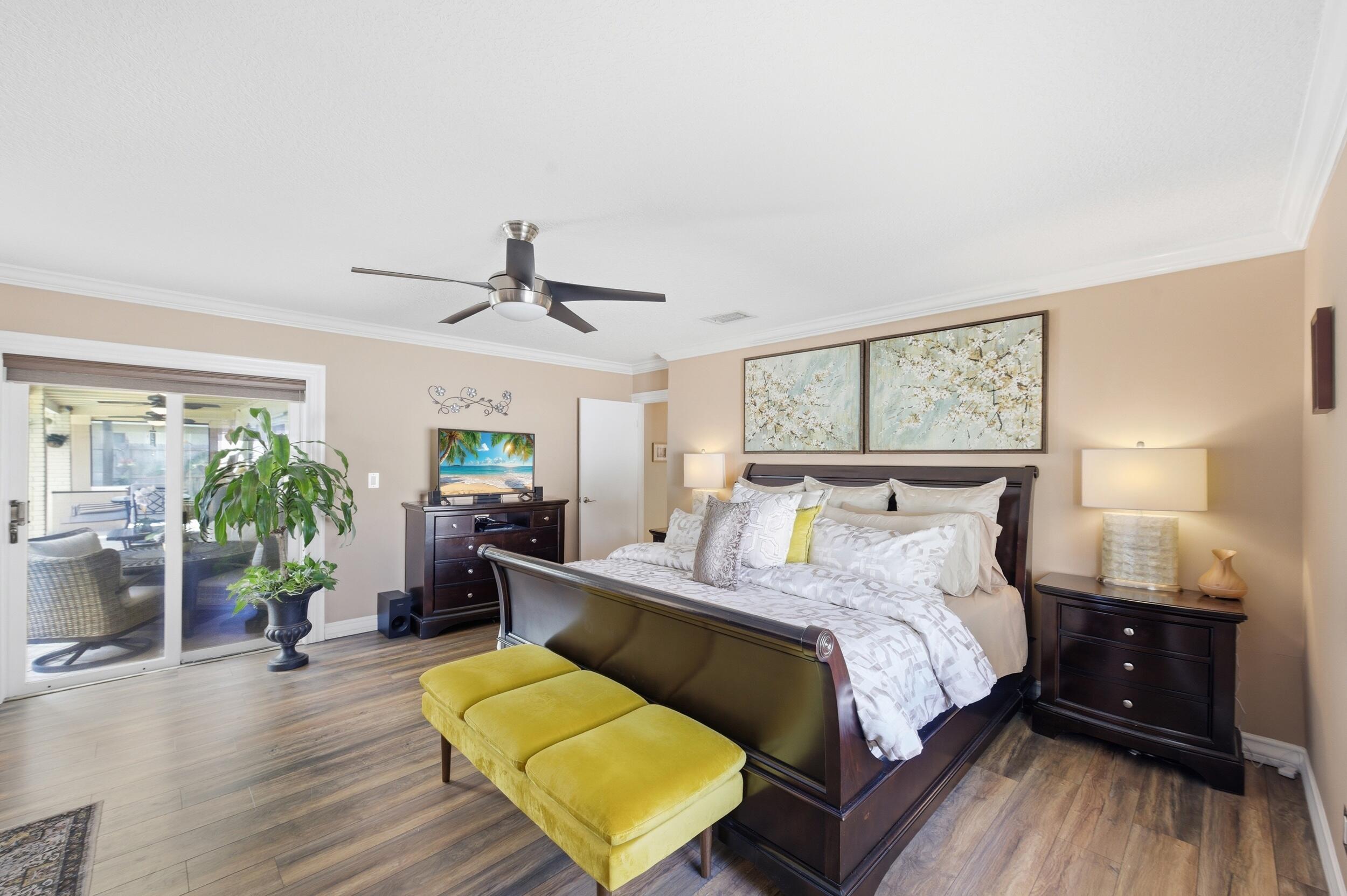 4780 Brandywine Drive Boca Raton, FL 33487 - Photo 17 of 43 a bedroom with a bed and wooden floor