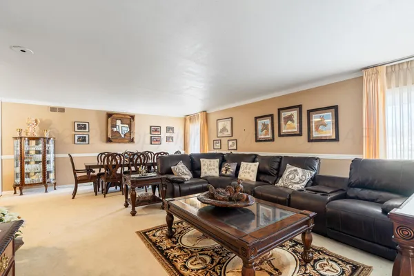 a living room with furniture wooden floor and a window