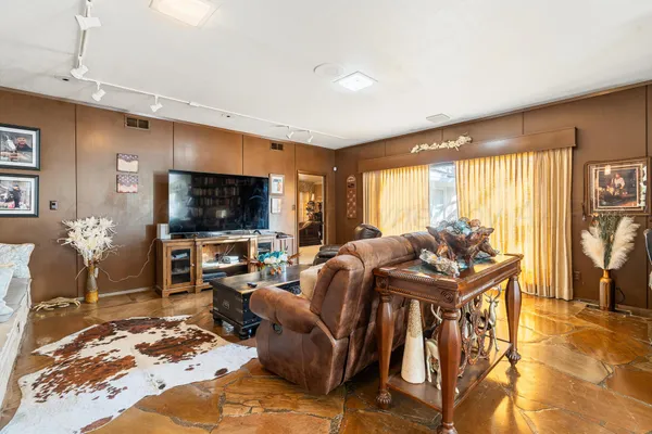 a living room with furniture a large window and a fireplace