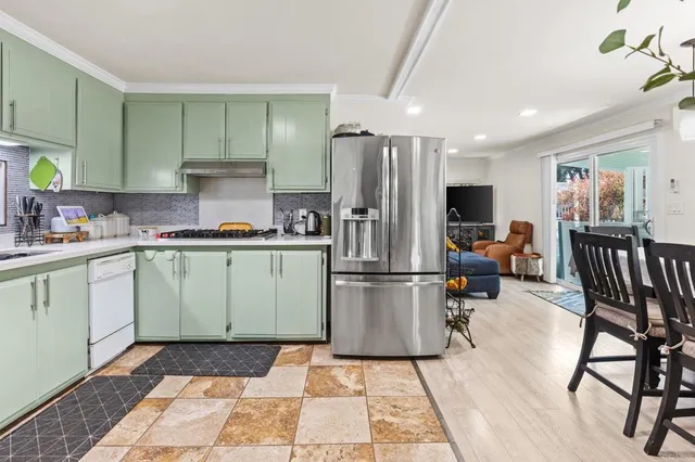 a kitchen with a sink appliances and cabinets