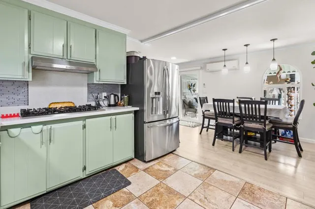 a kitchen with a sink a refrigerator and cabinets
