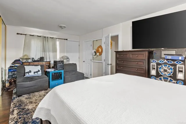 a bedroom with a bed and a flat screen tv