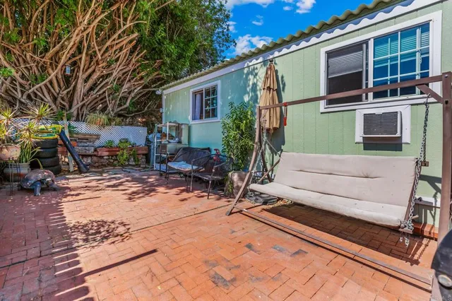 a backyard of a house with outdoor seating