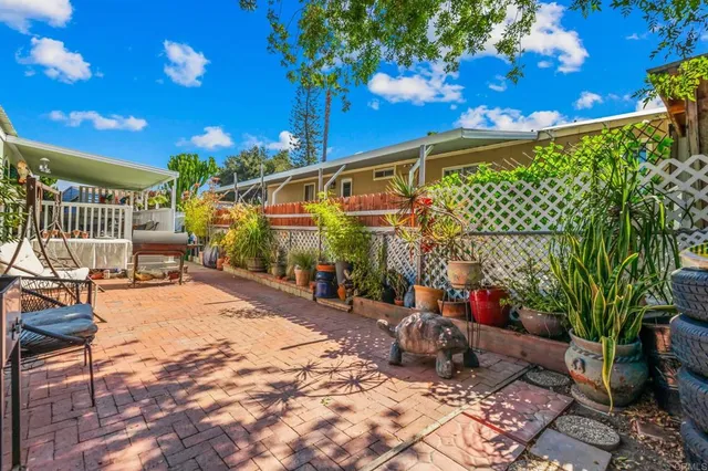 a view of a patio with table and chairs and potted plants