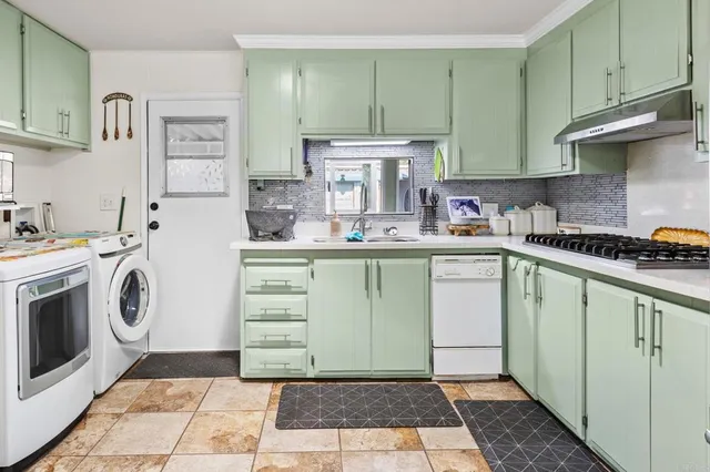 a kitchen with a sink a stove top oven and cabinets