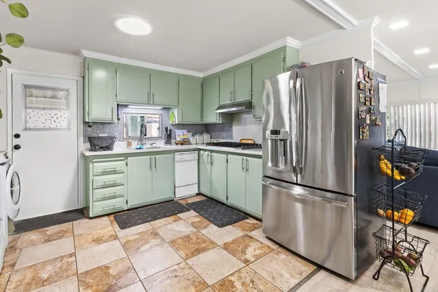 a kitchen with stainless steel appliances a refrigerator and a sink
