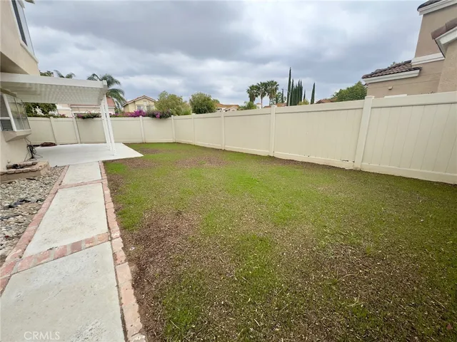 a view of a swimming pool with an outdoor seating and a bathroom