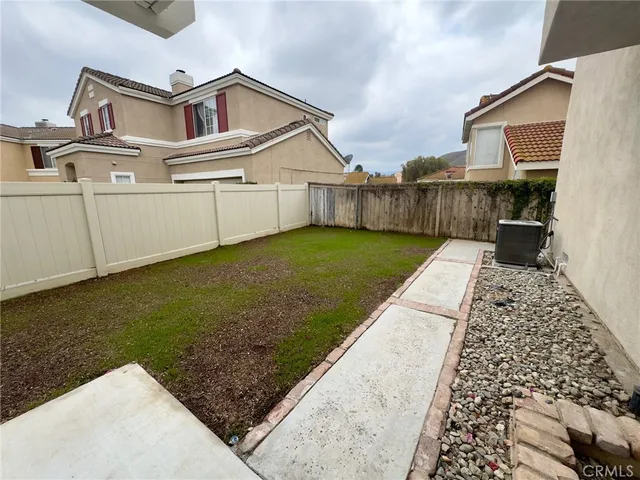 a view of a house with wooden fence