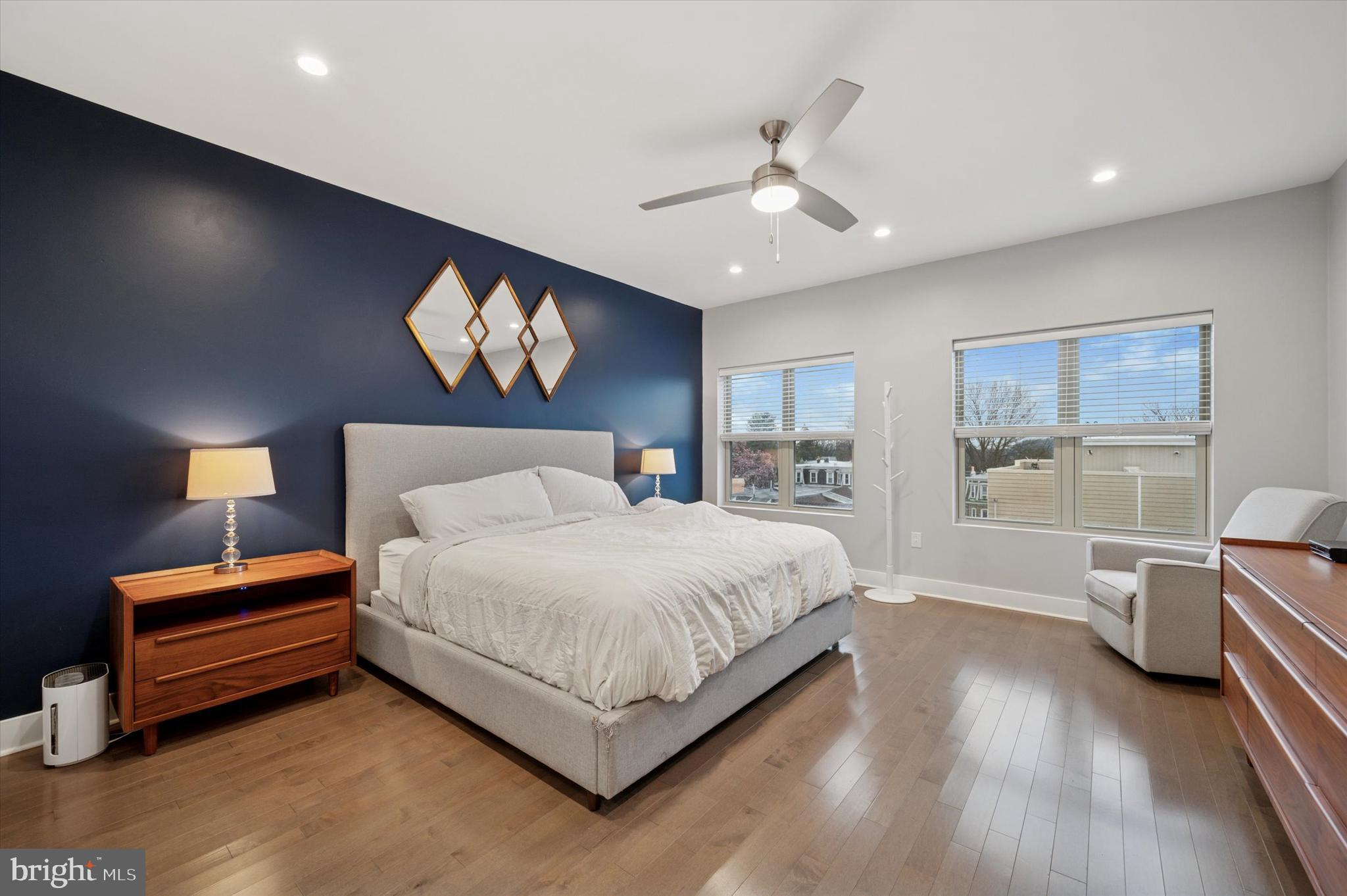 152 Kalos Street Philadelphia, PA 19128 - Photo 16 of 26 a spacious bedroom with a bed and a lamp on table