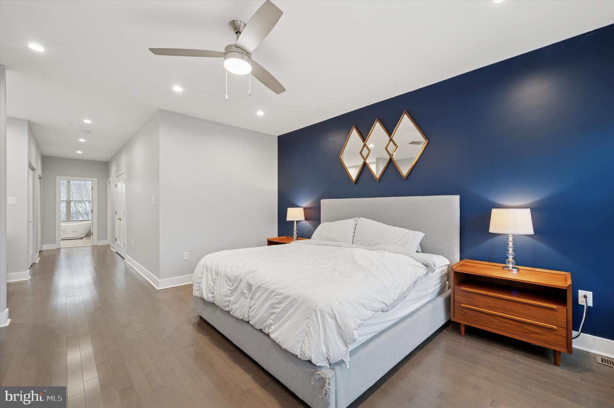 152 Kalos Street Philadelphia, PA 19128 - Photo 17 of 26 a bedroom with a bed and a chandelier