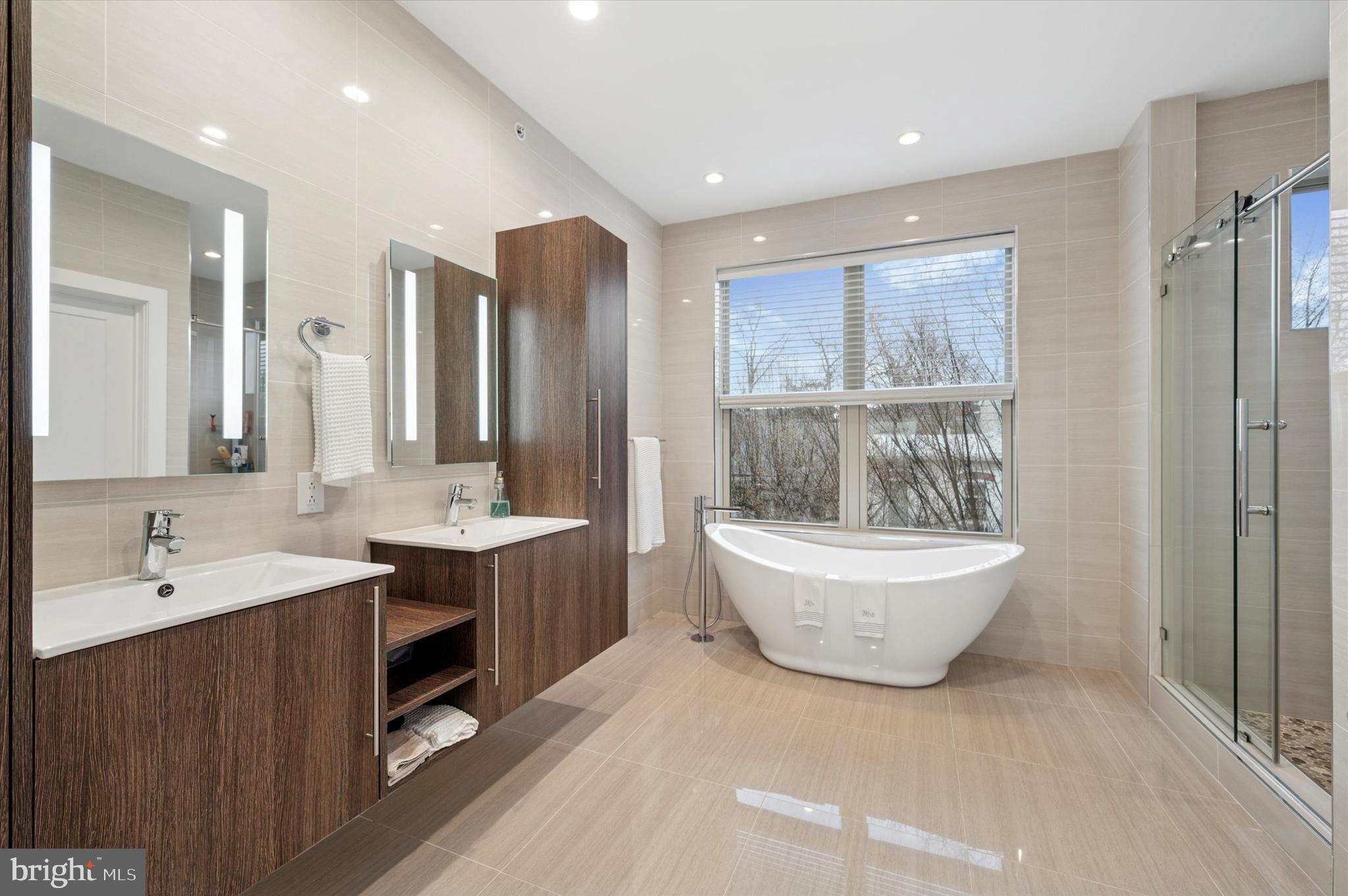 152 Kalos Street Philadelphia, PA 19128 - Photo 19 of 26 a bathroom with a double vanity sink a mirror and a bathtub