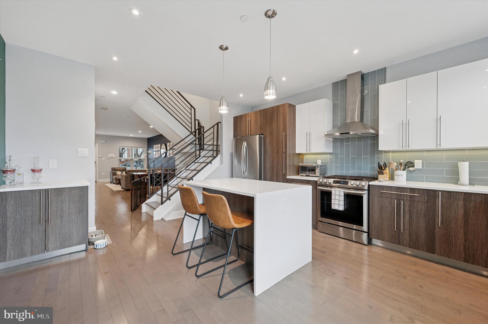 152 Kalos Street Philadelphia, PA 19128 - Photo 5 of 26 a kitchen with stainless steel appliances kitchen island granite countertop a refrigerator oven a sink dishwasher and white cabinets with wooden floor