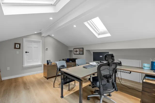 a view of a workspace with furniture and a workspace