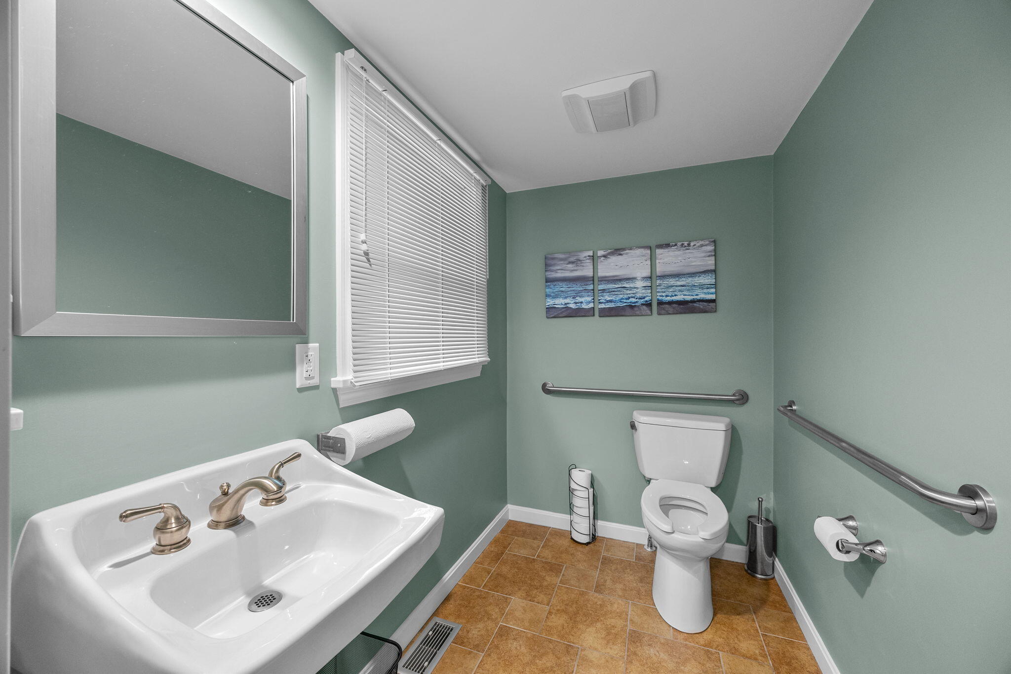 29 West Road Orleans, MA 02653 - Photo 25 of 27 a bathroom with a toilet sink and mirror