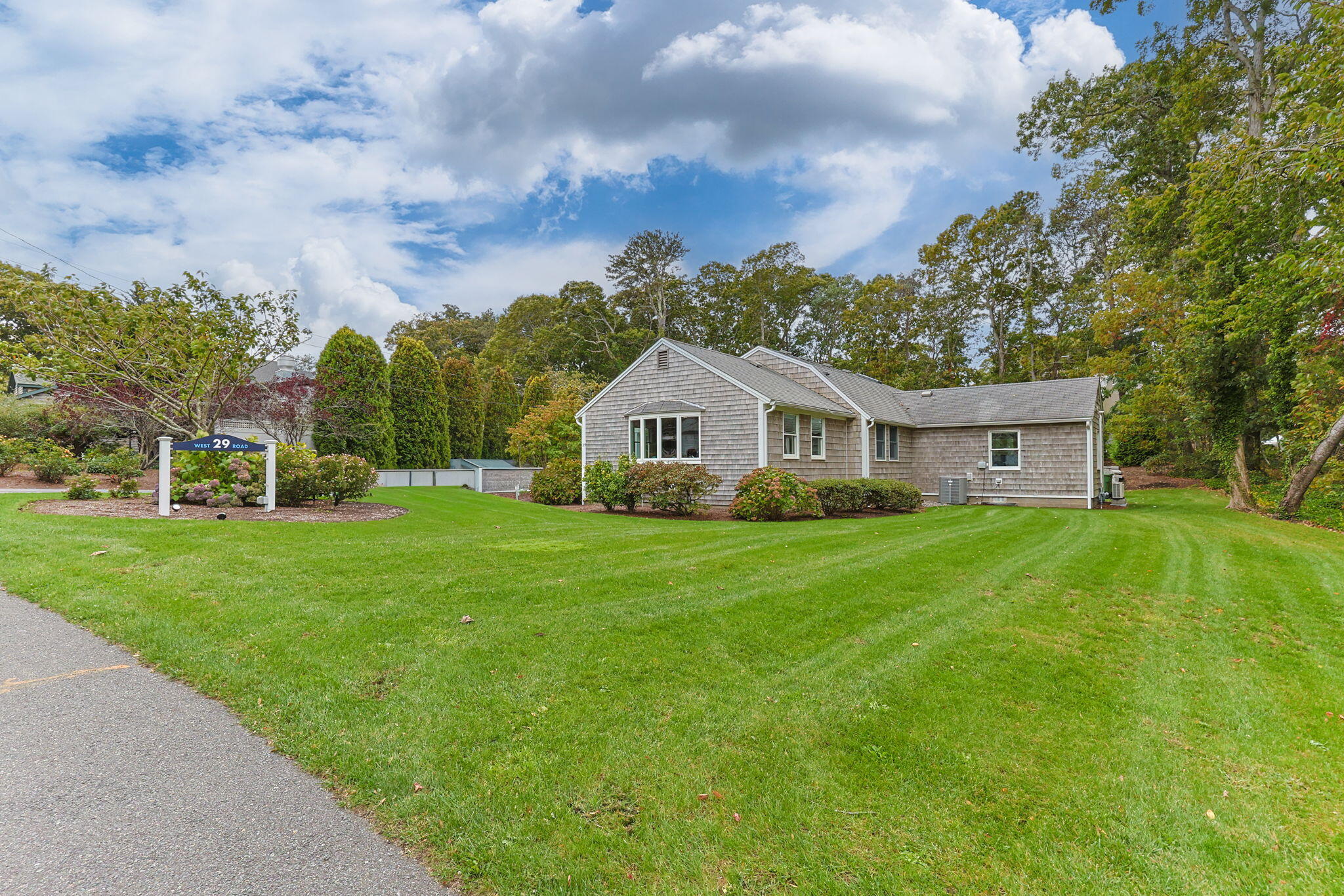29 West Road Orleans, MA 02653 - Photo 5 of 27 a front view of a house with garden