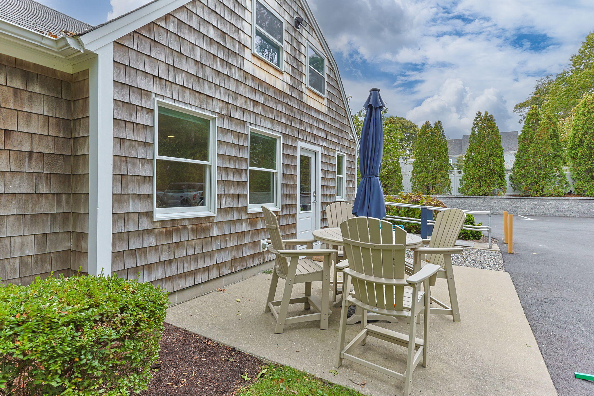 29 West Road Orleans, MA 02653 - Photo 8 of 27 a view of a patio with table and chairs and potted plants