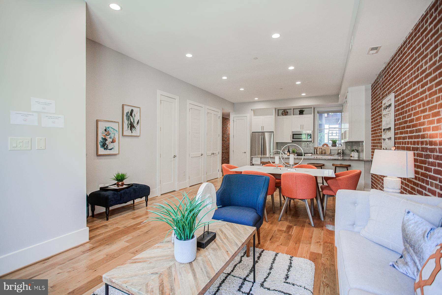 2024 16th Street Northwest, Unit C Washington, DC 20009 - Photo 12 of 27 a living room with stainless steel appliances kitchen island granite countertop furniture a rug kitchen view and a chandelier