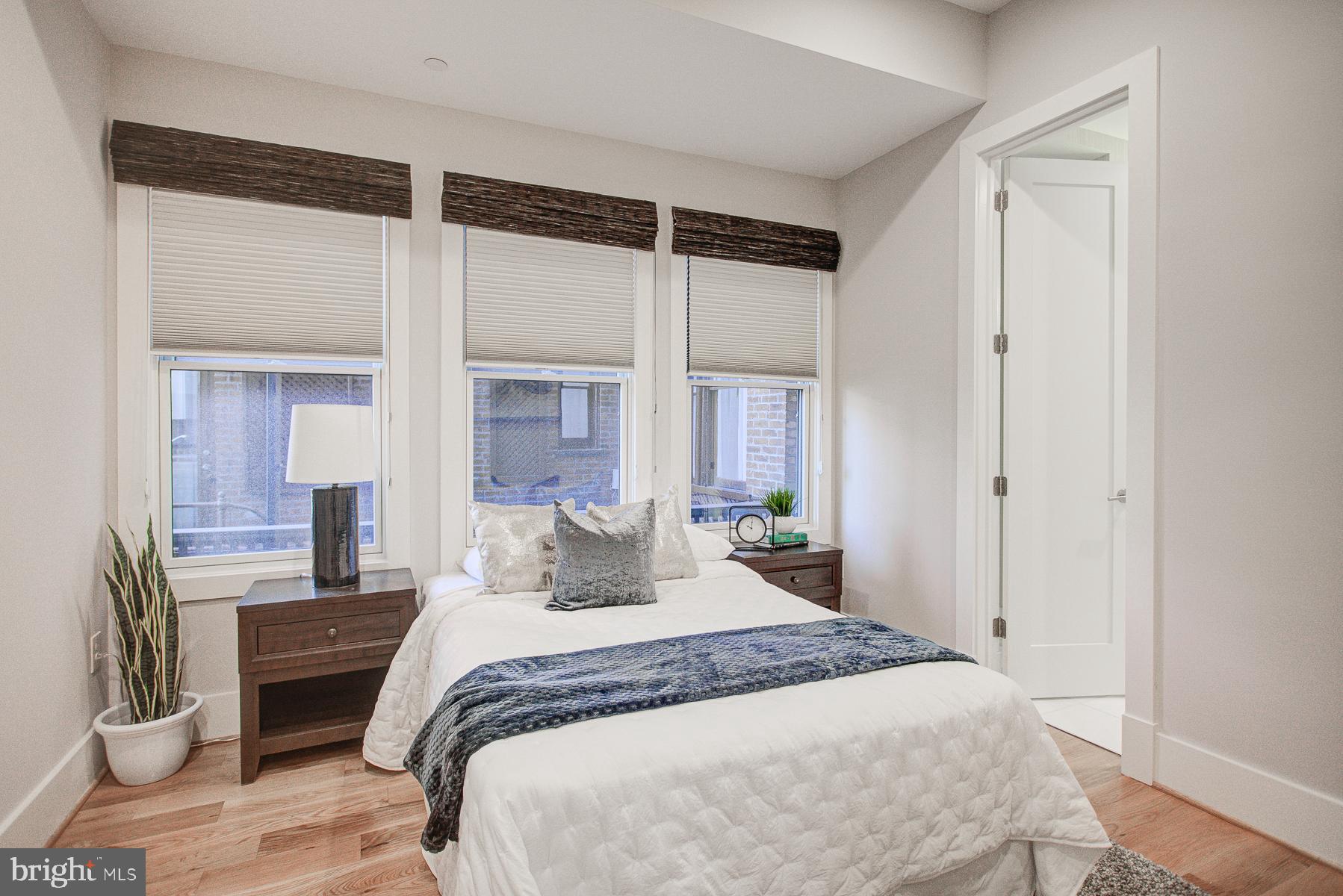 2024 16th Street Northwest, Unit C Washington, DC 20009 - Photo 19 of 27 a bedroom with a large bed and a window
