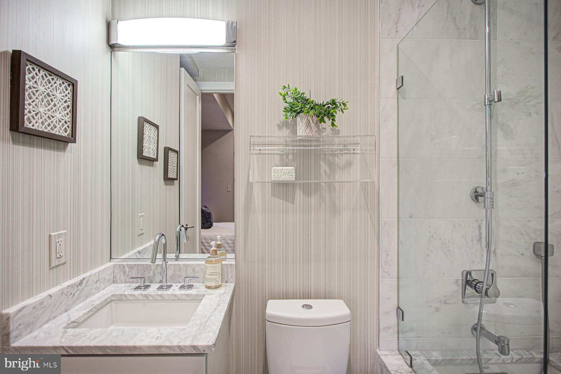2024 16th Street Northwest, Unit C Washington, DC 20009 - Photo 22 of 27 a bathroom with a sink toilet and shower
