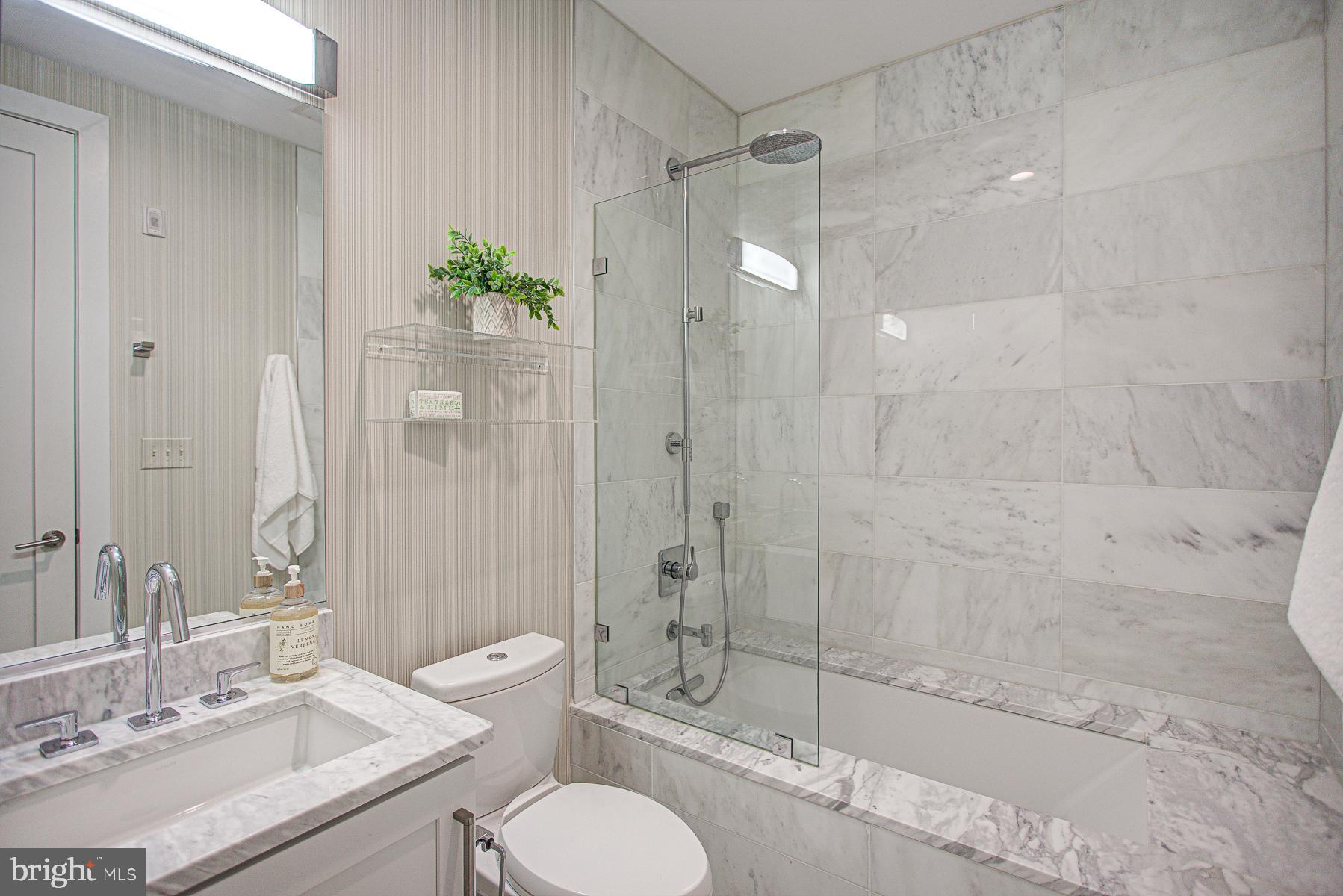 2024 16th Street Northwest, Unit C Washington, DC 20009 - Photo 23 of 27 a bathroom with a granite countertop bathtub shower sink mirror and toilet