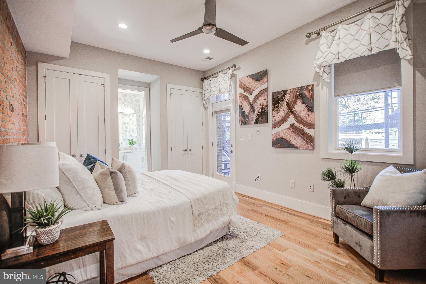 2024 16th Street Northwest, Unit C Washington, DC 20009 - Photo 26 of 27 a spacious bedroom with a bed and a couch