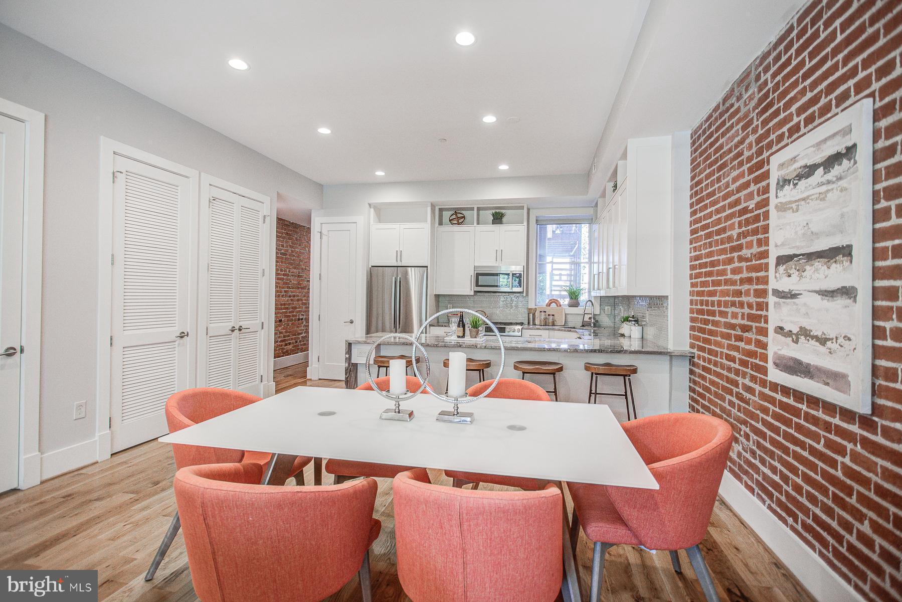 2024 16th Street Northwest, Unit C Washington, DC 20009 - Photo 8 of 27 a dining room with furniture a window and kitchen view