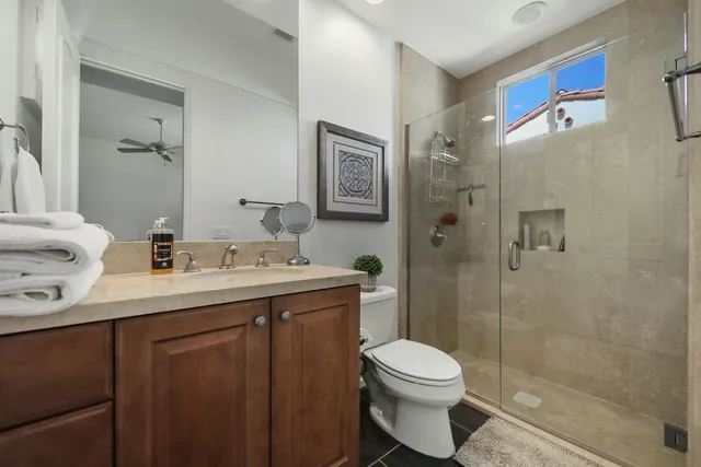 a bathroom with a double vanity sink toilet and shower