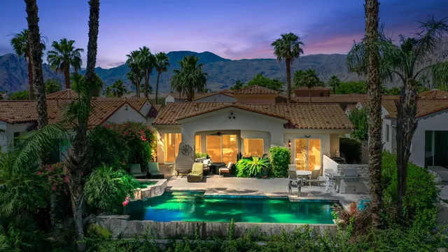 a view of a house with swimming pool and a yard