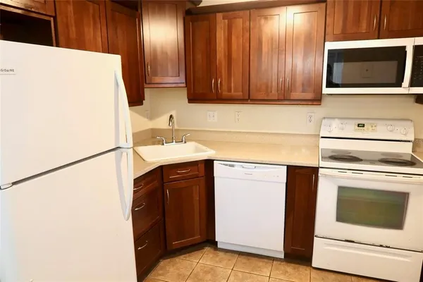 a kitchen with granite countertop cabinets stainless steel appliances and a counter space