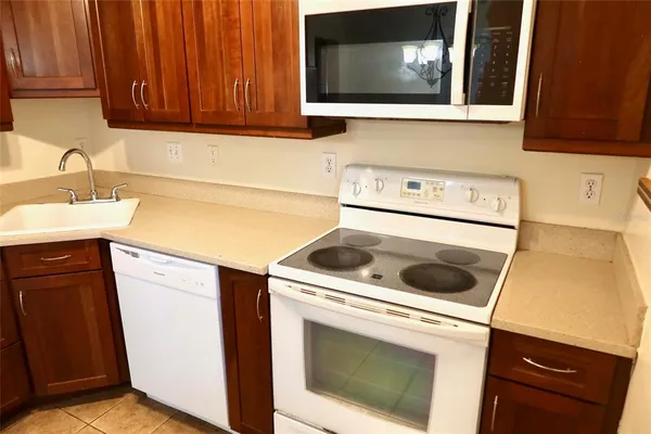 a kitchen with a stove microwave and sink