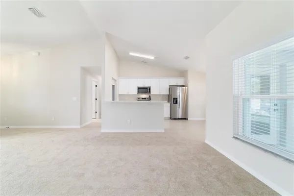 a large kitchen with white cabinets and stainless steel appliances