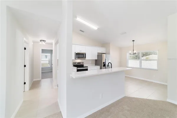 a kitchen with stainless steel appliances a refrigerator and a stove top oven