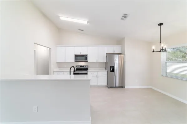 a kitchen with cabinets and stainless steel appliances
