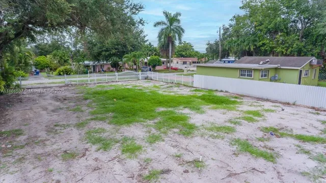 a view of a swimming pool with a patio and a yard
