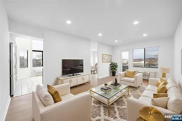 a living room with furniture a rug and a flat screen tv