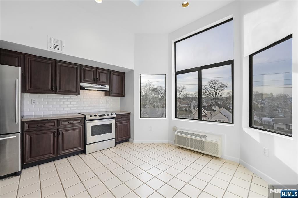850 Main Street, Unit 306 Hackensack, NJ 07601 - Photo 3 of 8 a kitchen with stainless steel appliances granite countertop a stove top oven a sink and a granite counter tops